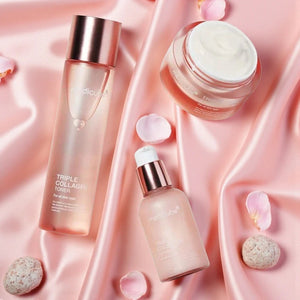 Skin TOGO Medicube Triple Collagen skincare set including toner, serum, and cream on pink satin fabric with petals.