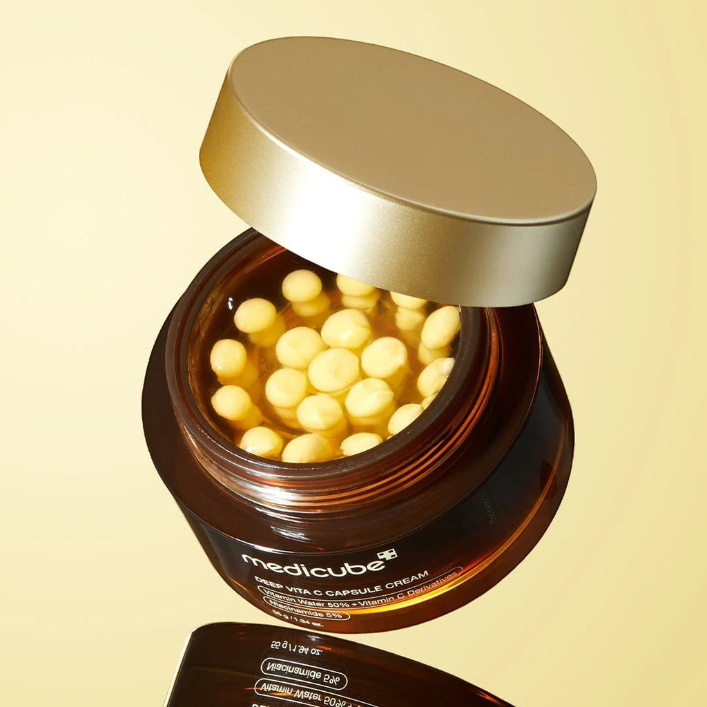 Skin TOGO Medicube Deep Vitamin C Capsule Cream in a brown jar with visible yellow vitamin capsules and gold lid.