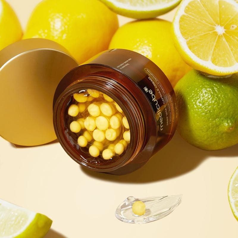 Skin TOGO Medicube Deep Vitamin C Capsule Cream in a brown jar with visible yellow vitamin capsules and fresh citrus