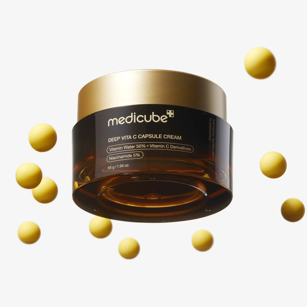 Skin TOGO Medicube Deep Vitamin C Capsule Cream jar surrounded by floating yellow vitamin spheres for skin brightening.