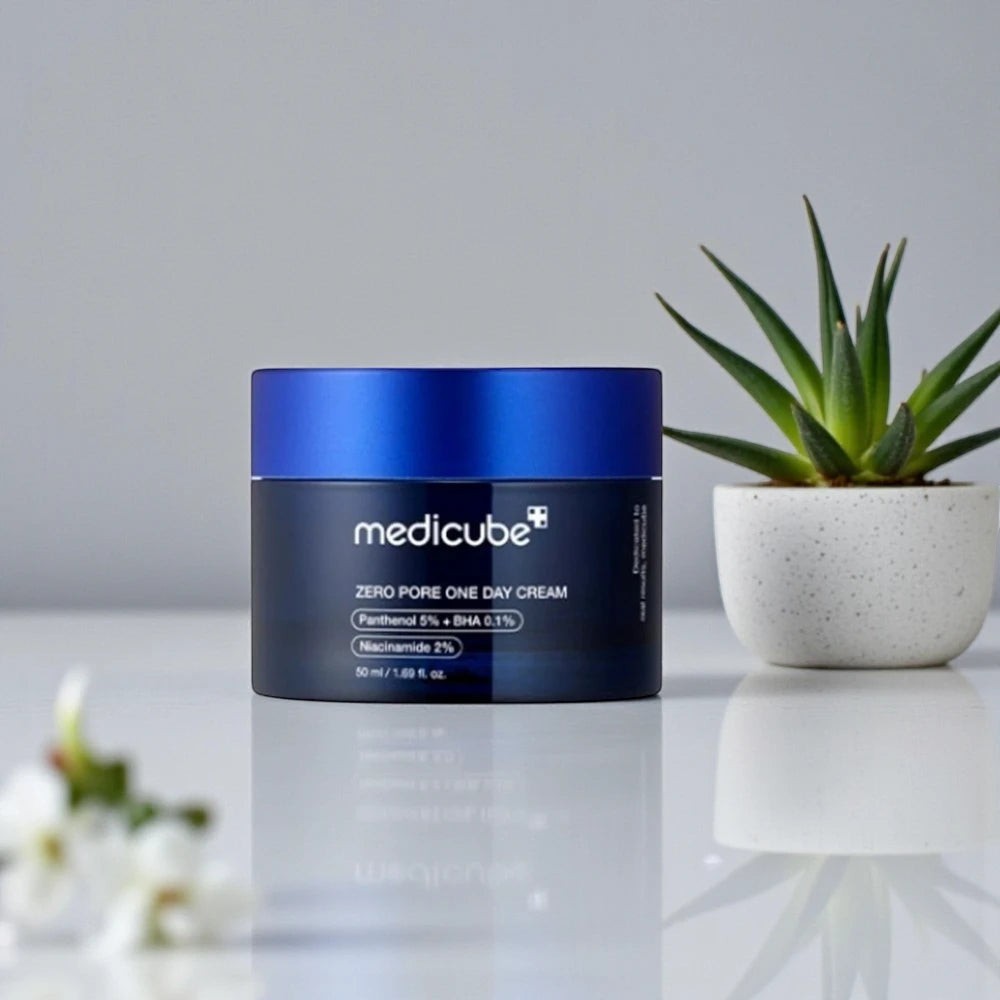 Skin TOGO Medicube Zero Pore One-day Cream in a dark blue jar with a matte finish, placed on a white surface.