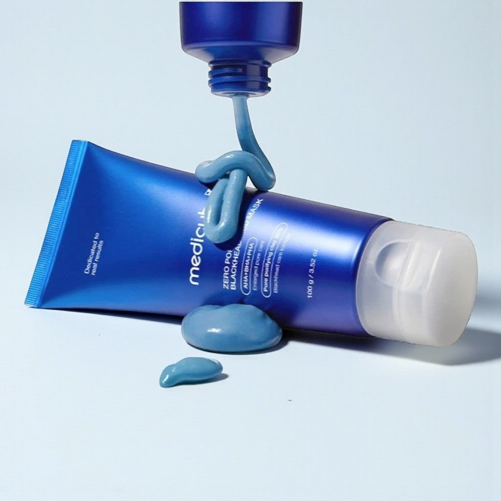Skin TOGO Medicube Zero Pore Blackhead Mud Mask in a blue tube with thick blue clay texture being squeezed out.