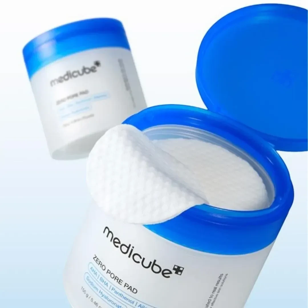 Skin TOGO Medicube Zero Pore Pad exfoliating toner pads in a blue and white container with a textured cotton pad.