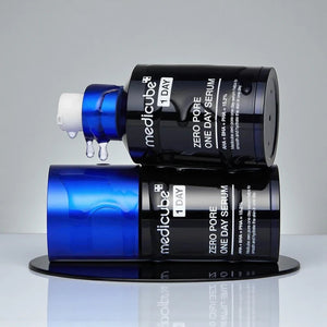 Skin TOGO Medicube Zero Pore One-day Serum bottles stacked with clear serum dripping from the pump dispenser.