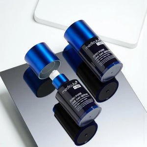 Skin TOGO Medicube Zero Pore One-day Serum bottles with blue caps on a reflective surface for pore refinement.