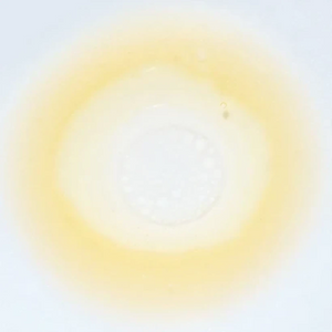 Skin TOGO Meebak Glow Serum Mist with Vitamin C and sea buckthorn extract, shown as a light golden liquid droplet.