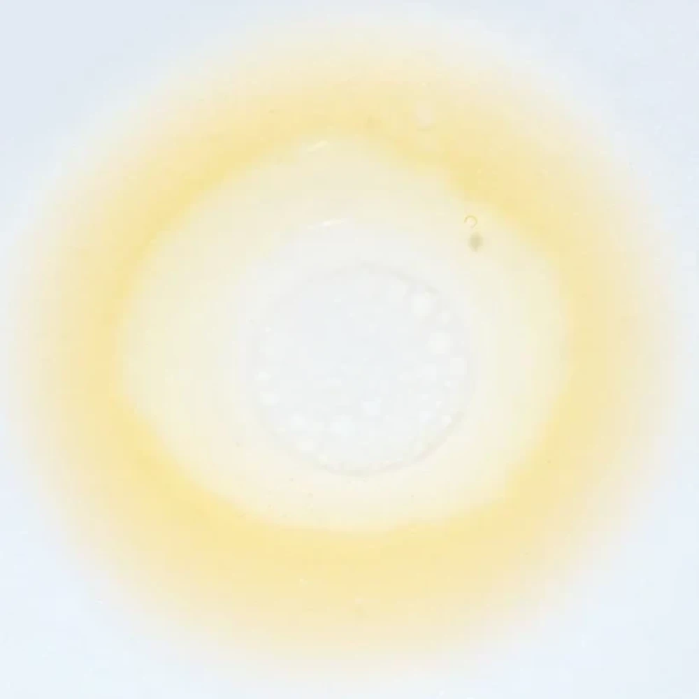 Skin TOGO Meebak Glow Serum Mist with Vitamin C and sea buckthorn extract, shown as a light golden liquid droplet.