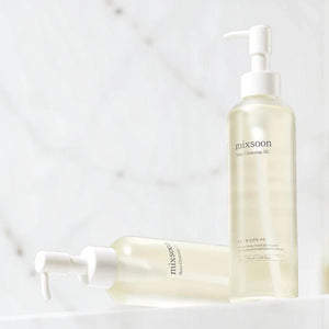 Skin TOGO Mixsoon Bean Cleansing Oil bottles with pump dispensers for deep facial makeup removal and nourishment.