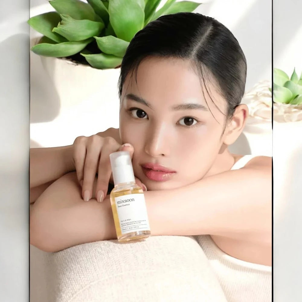 Skin TOGO model holding a bottle of Mixsoon Bean Essence, a nourishing fermented skincare serum for mature skin.
