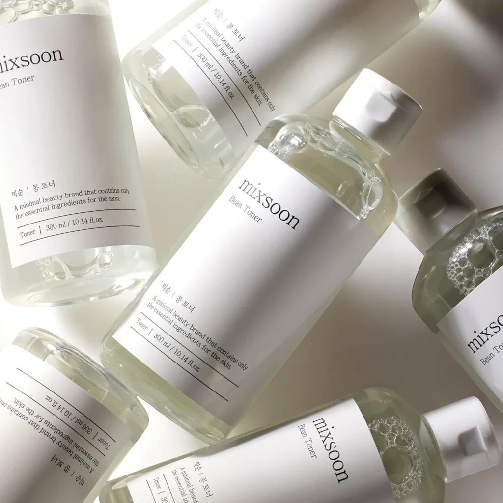 Skin TOGO Mixsoon Bifida Toner bottles arranged in a minimalist flat lay, showcasing the clear liquid skincare product.