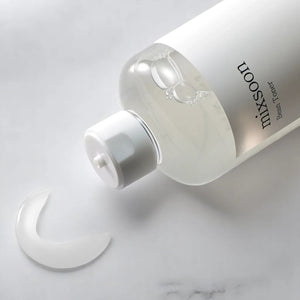 Skin TOGO Mixsoon Bifida Toner in a clear bottle with a white cap, showing a drop of the lightweight liquid texture.