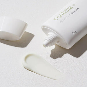 Skin TOGO Mixsoon Centella Sun Cream in a white tube with a dispensed creamy texture on a textured white surface.