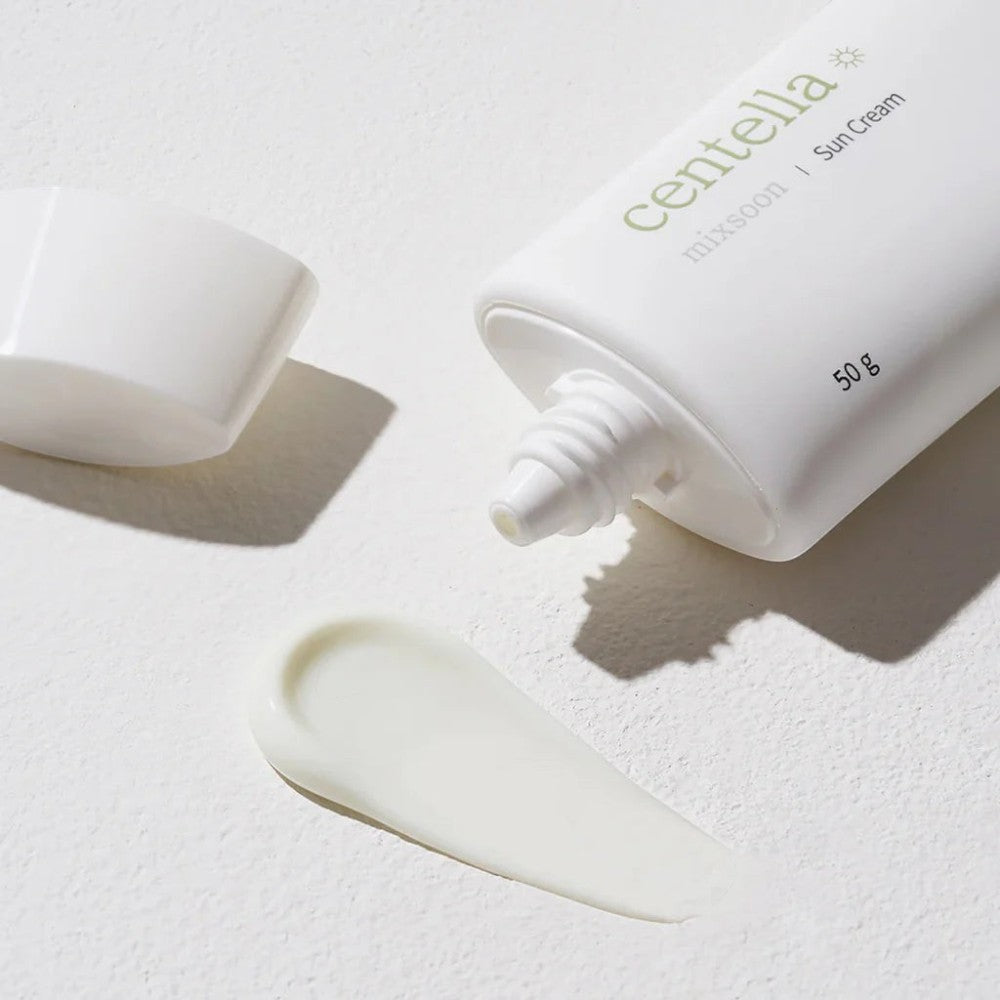 Skin TOGO Mixsoon Centella Sun Cream in a white tube with a dispensed creamy texture on a textured white surface.