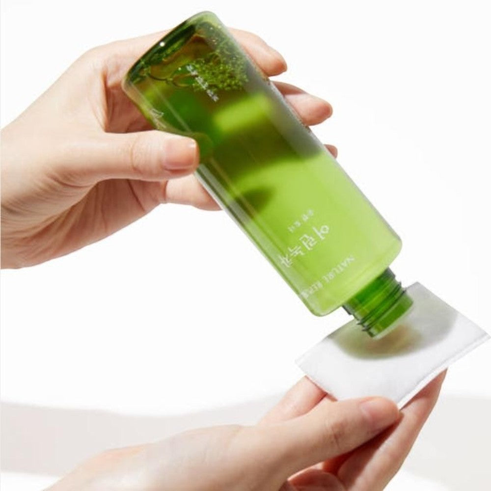 Skin TOGO Nature Republic Young Green Tea Mild Toner being poured onto a cotton pad for gentle facial skincare