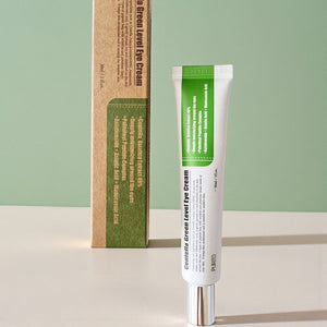Skin TOGO Purito Centella Green Level eye cream tube and its eco-friendly cardboard packaging on a green background.