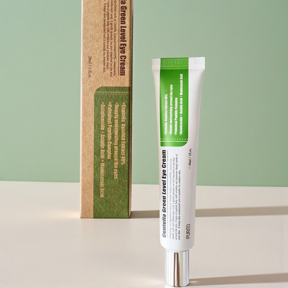 Skin TOGO Purito Centella Green Level eye cream tube and its eco-friendly cardboard packaging on a green background.