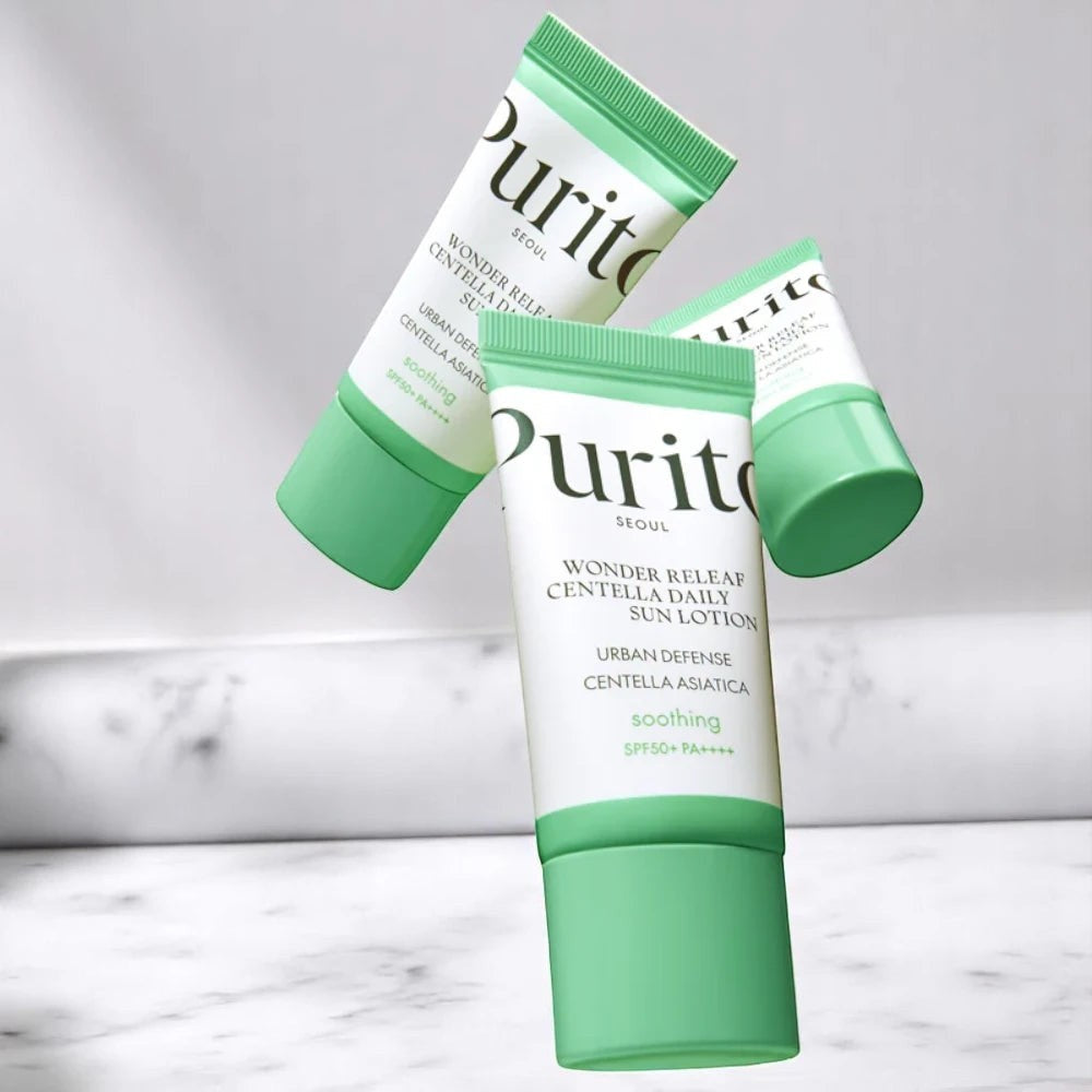 Skin TOGO Purito Wonder Releaf Centella Daily Sun Cream tubes with SPF 50+ protection on a marble surface
