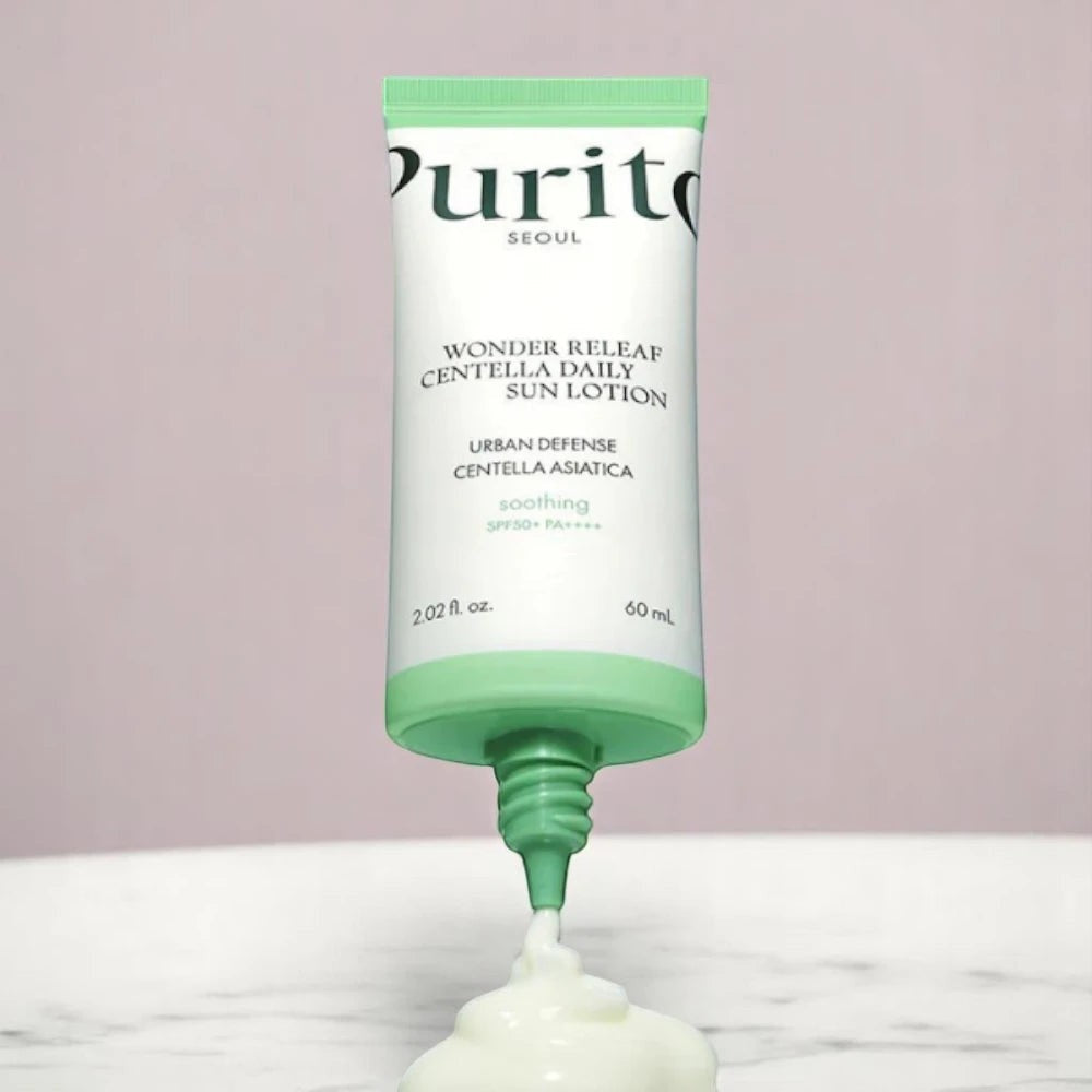 Skin TOGO Purito Wonder Releaf Centella Daily Sun Cream tube dispensing white moisturizing lotion on marble surface