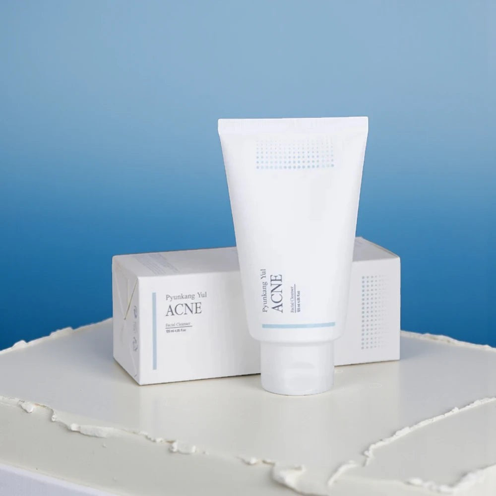 Skin TOGO Pyunkang Yul ACNE Facial Cleanser in a white tube and matching box for acne-prone skin on a white surface.