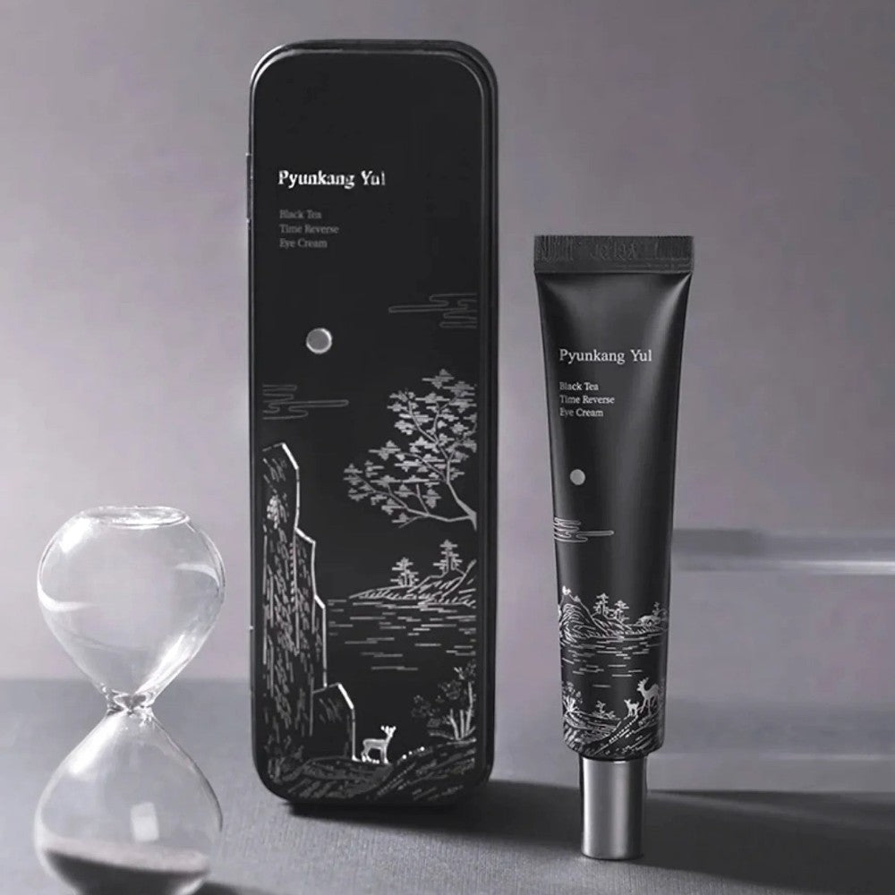 Skin TOGO Pyunkang Yul Black Tea Time Reverse Eye Cream tube and decorative black tin with hourglass on grey background
