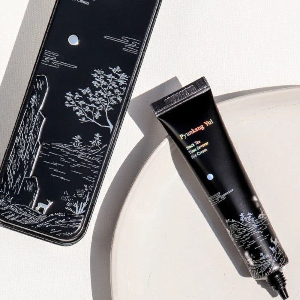 Skin TOGO Pyunkang Yul Black Tea Time Reverse Eye Cream in a black tube with elegant white landscape illustration.