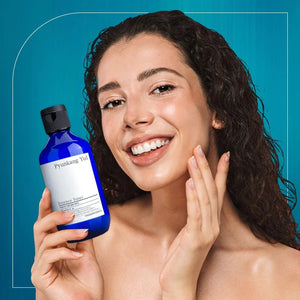 Skin TOGO model smiling while holding a blue 200ml bottle of Pyunkang Yul Essence Toner for sensitive skin.