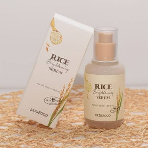 Skin TOGO SKINFOOD Rice Brightening Serum bottle and its white cardboard box featuring rice illustrations