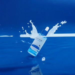 Skin TOGO Round Lab Birch Juice Moisturizing Ampoule bottle splashing in water against a vibrant blue background.