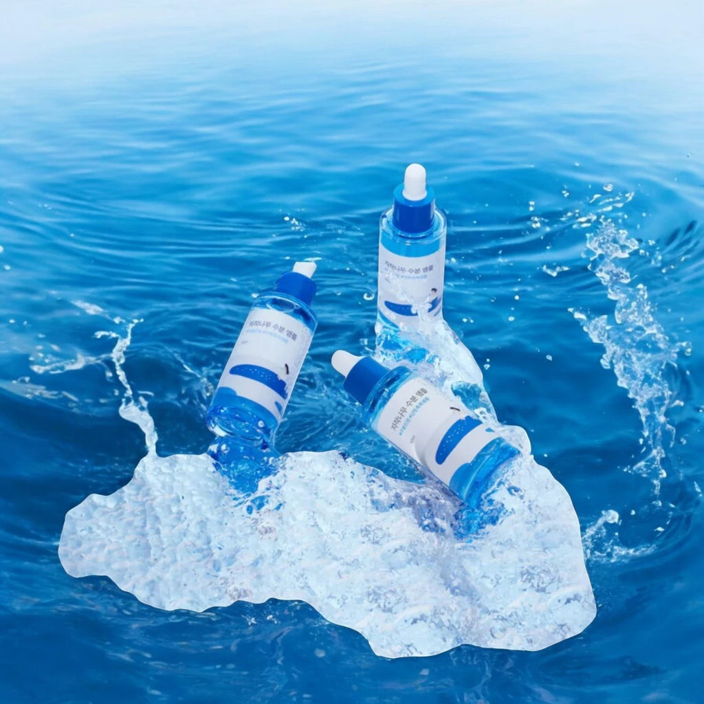 Skin TOGO Round Lab Birch Juice Moisturizing Ampoule bottles resting on ice in water, highlighting deep hydration.
