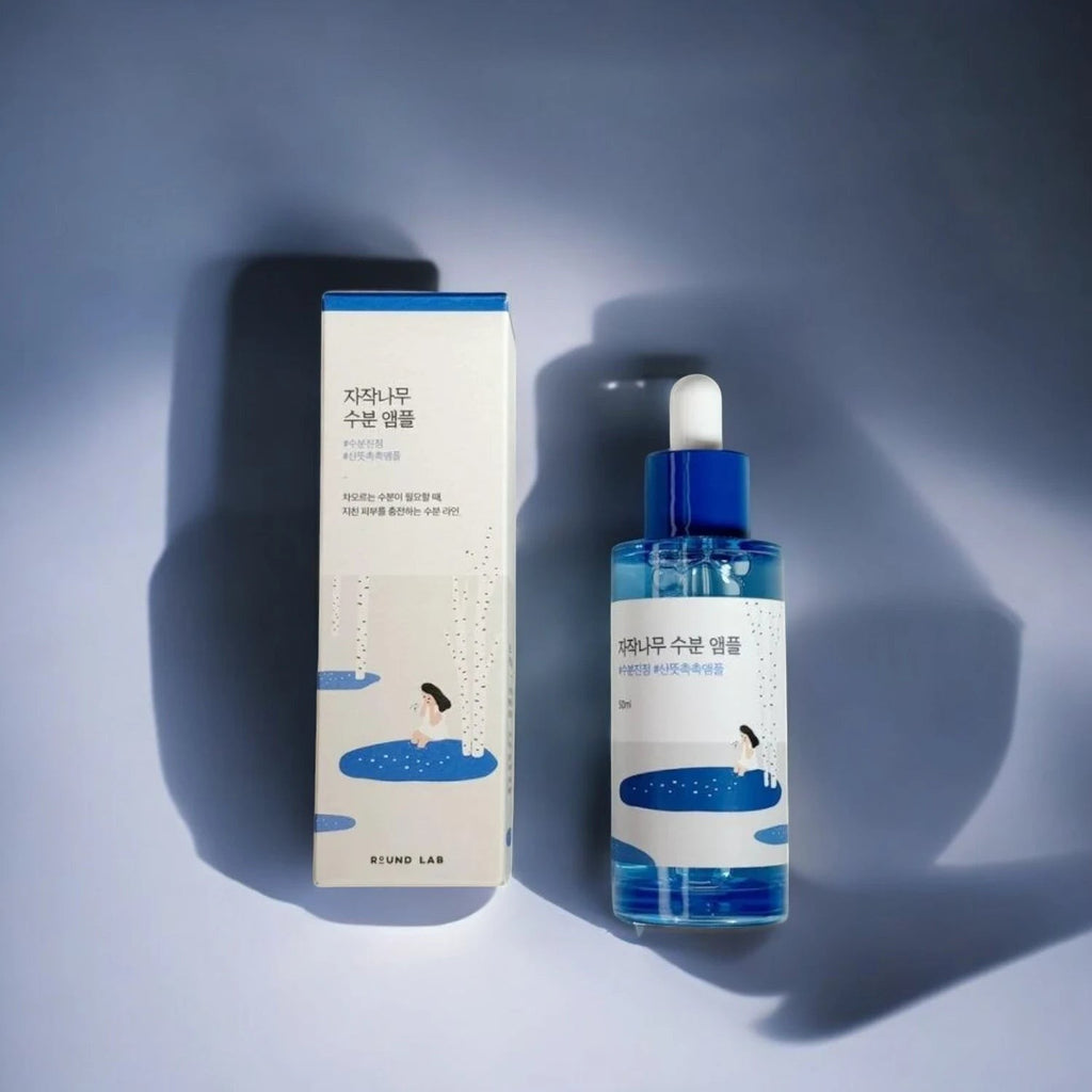 Skin TOGO Round Lab Birch Juice Moisturizing Ampoule bottle and box with blue accents and birch tree illustration.