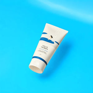 Skin TOGO Round Lab Birch Juice Moisturizing Cleanser tube on a bright blue background.