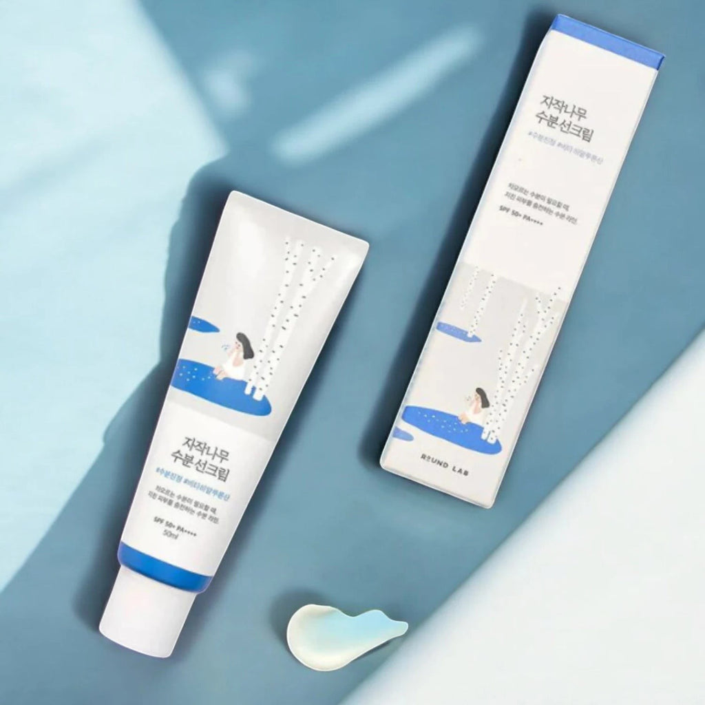 Skin TOGO Round Lab Birch Juice Moisturizing Sun Cream tube and box with blue and white birch tree design