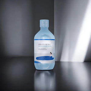 Skin TOGO Round Lab Birch Juice Moisturizing Toner in a 300ml clear bottle with a minimalist blue and white label.