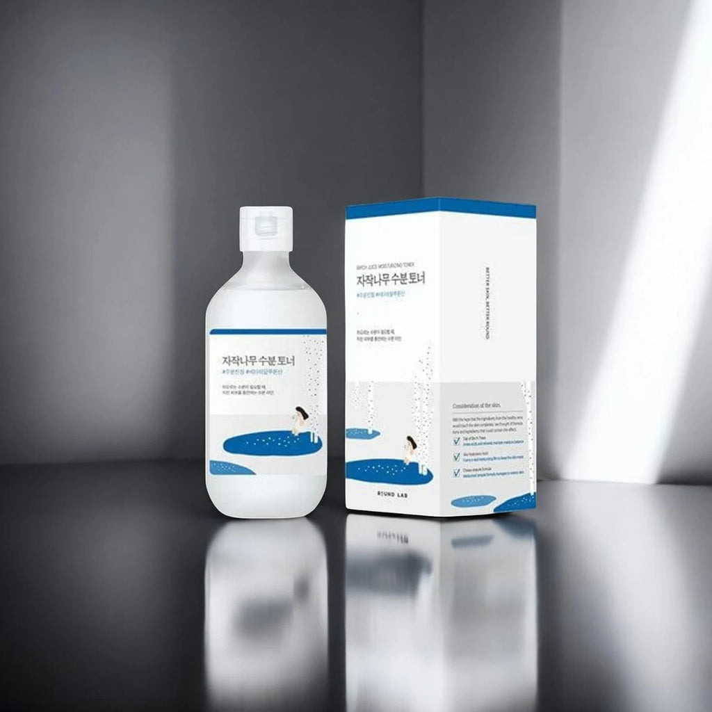 Skin TOGO Round Lab Birch Juice Moisturizing Toner bottle and packaging box on a minimalist grey surface.