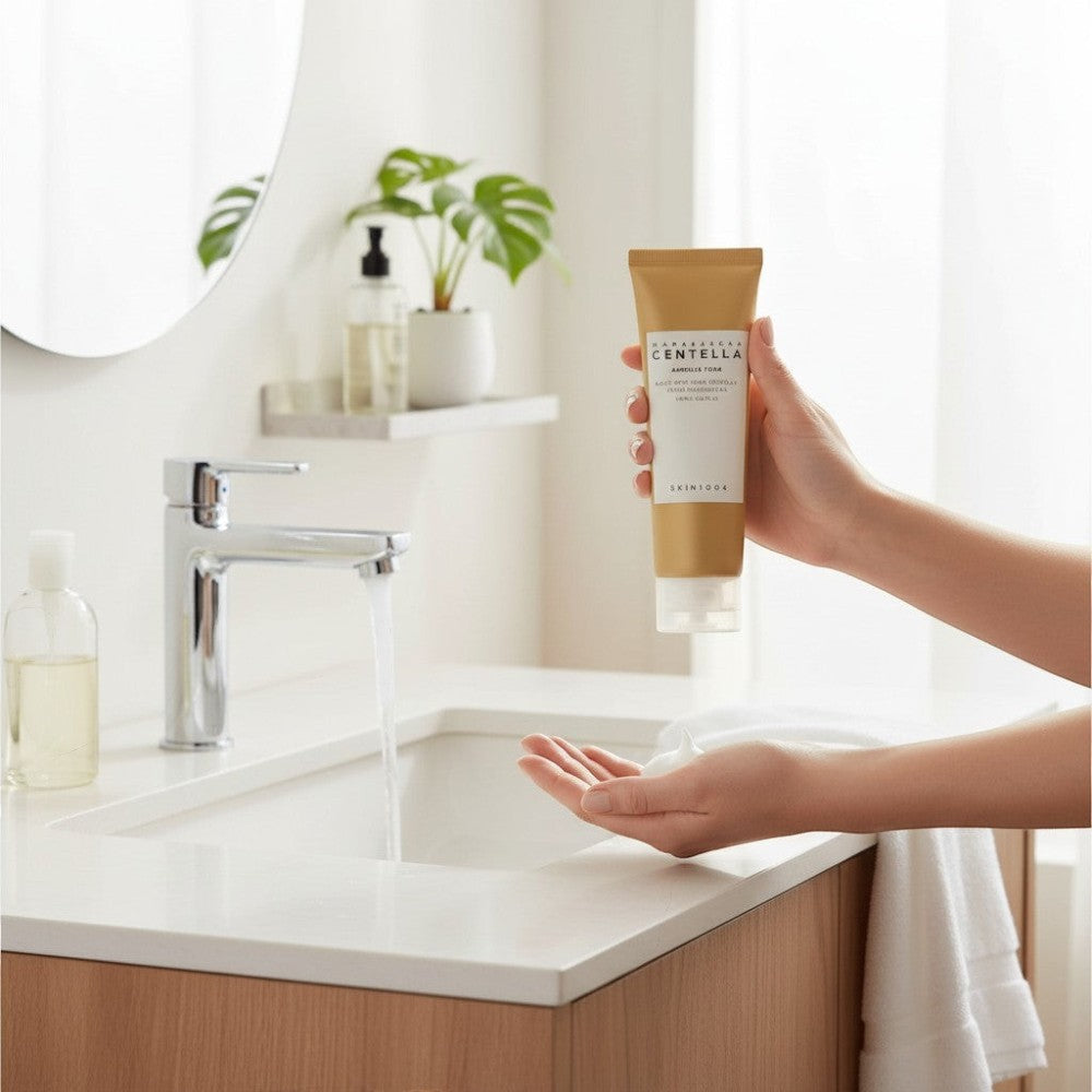 Skin TOGO SKIN1004 Madagascar Centella Ampoule Foam being dispensed into hands in a bright, modern bathroom.