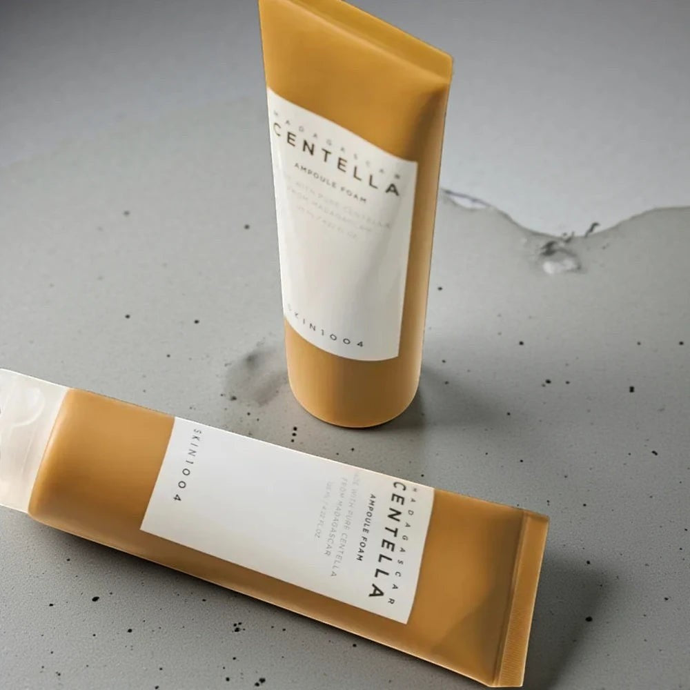 Skin TOGO SKIN1004 Madagascar Centella Ampoule Foam tubes on a grey textured surface for sensitive skin care.
