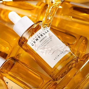 Skin TOGO SKIN1004 Madagascar Centella Ampoule with golden soothing serum pouring into a glass dropper bottle