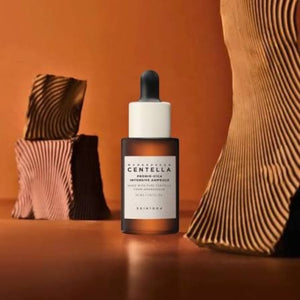 Skin TOGO SKIN1004 Madagascar Centella Probio-Cica Intensive Ampoule in a brown glass dropper bottle on a warm background