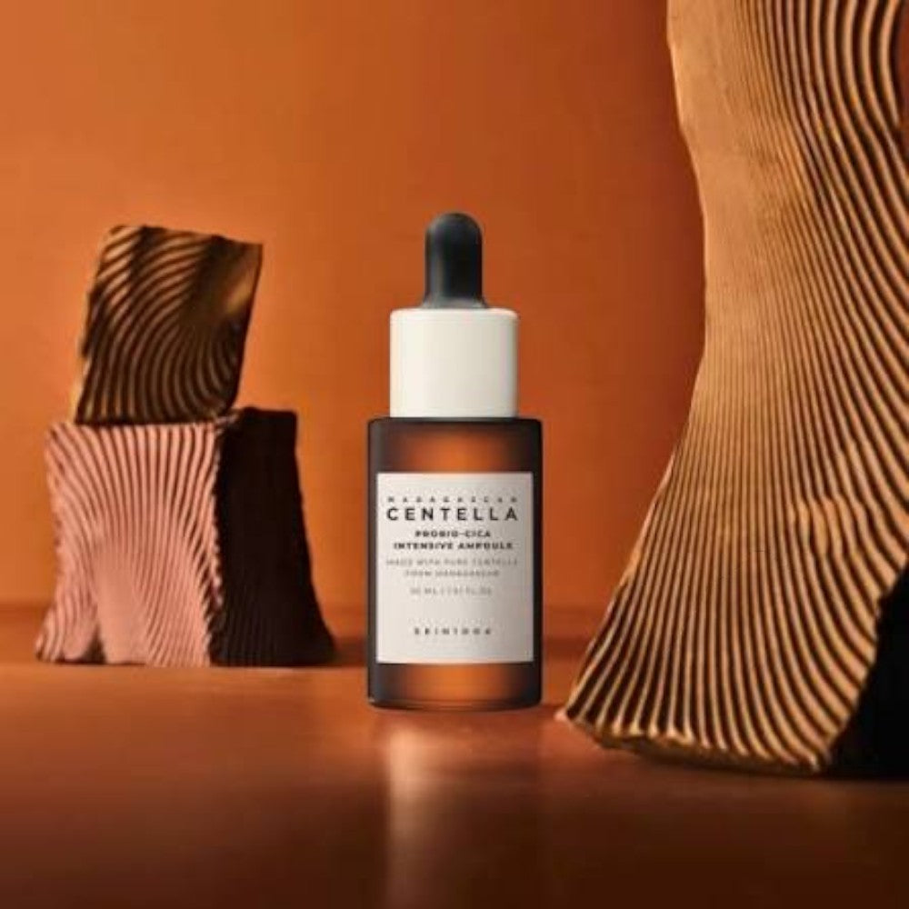 Skin TOGO SKIN1004 Madagascar Centella Probio-Cica Intensive Ampoule in a brown glass dropper bottle on a warm background