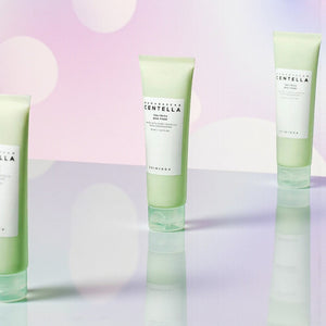 Skin TOGO SKIN1004 Madagascar Centella Tea-Trica BHA Foam cleanser tubes on a reflective surface with bokeh background