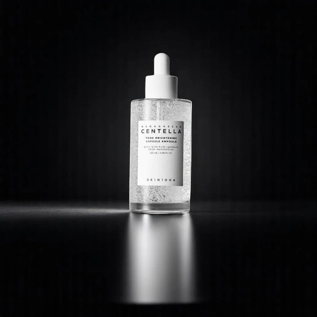 Skin TOGO SKIN1004 Centella Tone Brightening Capsule Ampoule in a clear glass dropper bottle on a dark background.