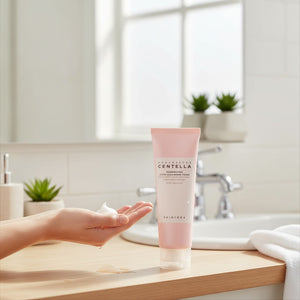 Skin TOGO SKIN1004 Madagascar Centella Poremizing Deep Cleansing Foam in a pink tube with creamy foam on a hand.