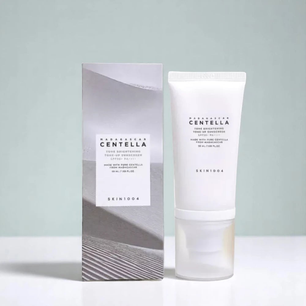 Skin TOGO SKIN1004 Madagascar Centella Tone Brightening Tone-Up Sunscreen SPF50+ tube and box on a white surface.