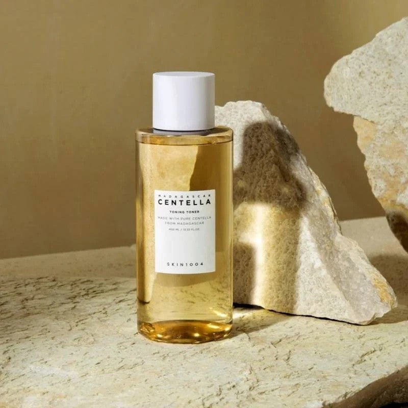 Skin TOGO SKIN1004 Madagascar Centella Toning Toner in a 400ml clear bottle placed on a textured stone surface.