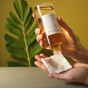 Skin TOGO SKIN1004 Madagascar Centella Toning Toner being poured onto a cotton pad for gentle skincare application.