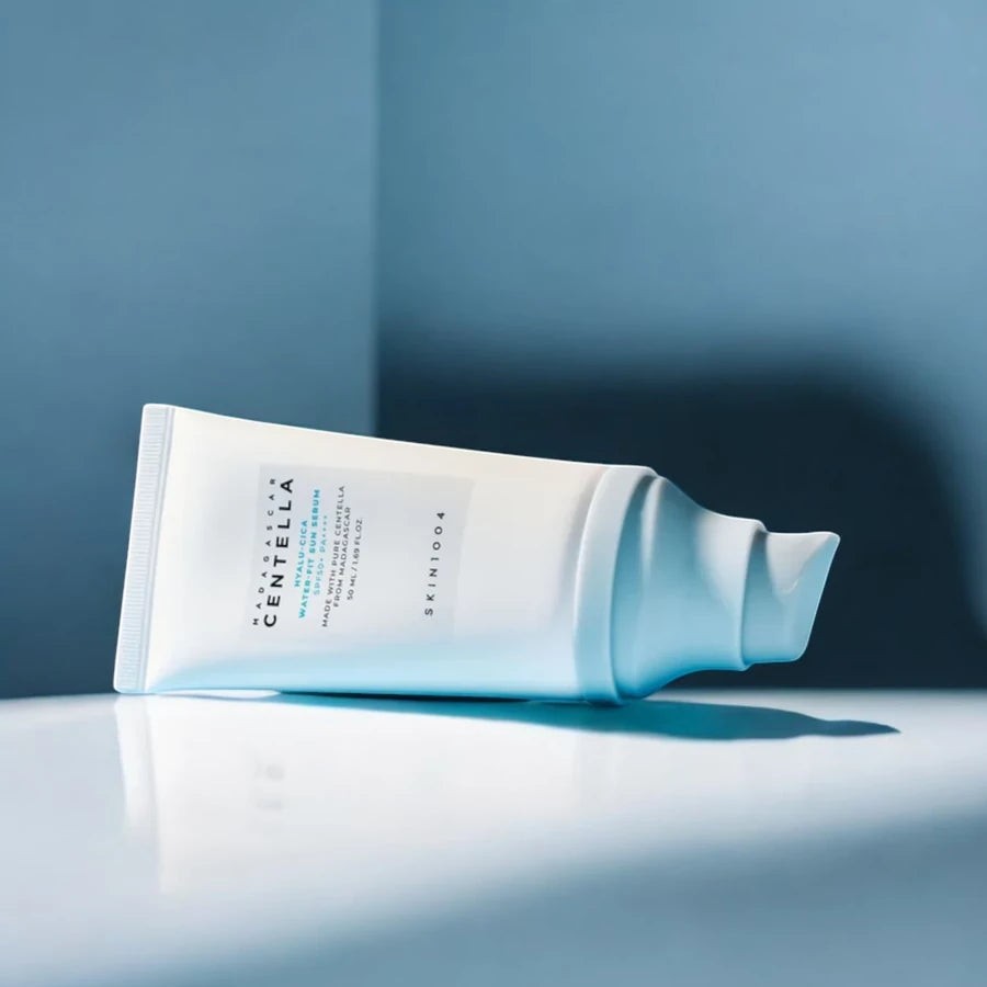 Skin TOGO SKIN1004 Madagascar Centella Hyalu-Cica Water-Fit Sun Serum tube on a reflective surface
