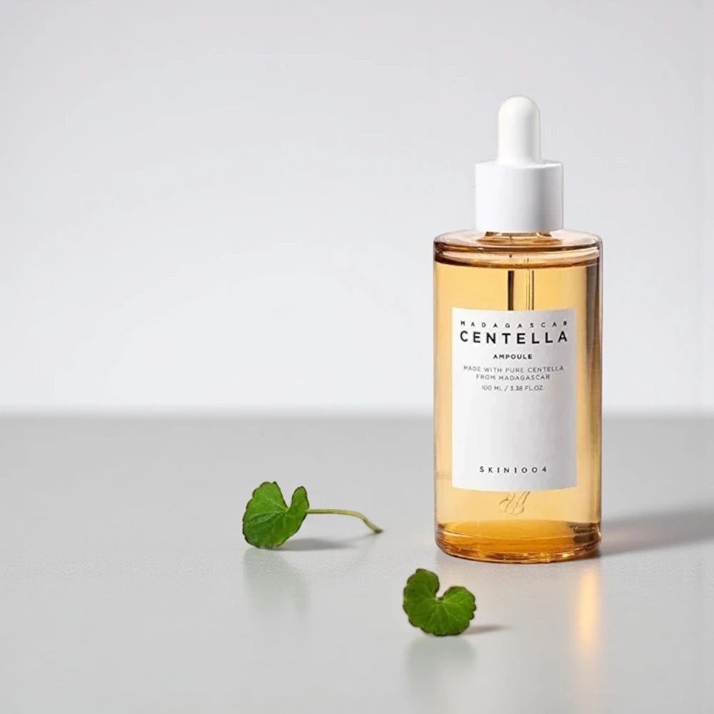 Skin TOGO SKIN1004 Madagascar Centella Ampoule in a clear glass dropper bottle with two small green centella leaves.