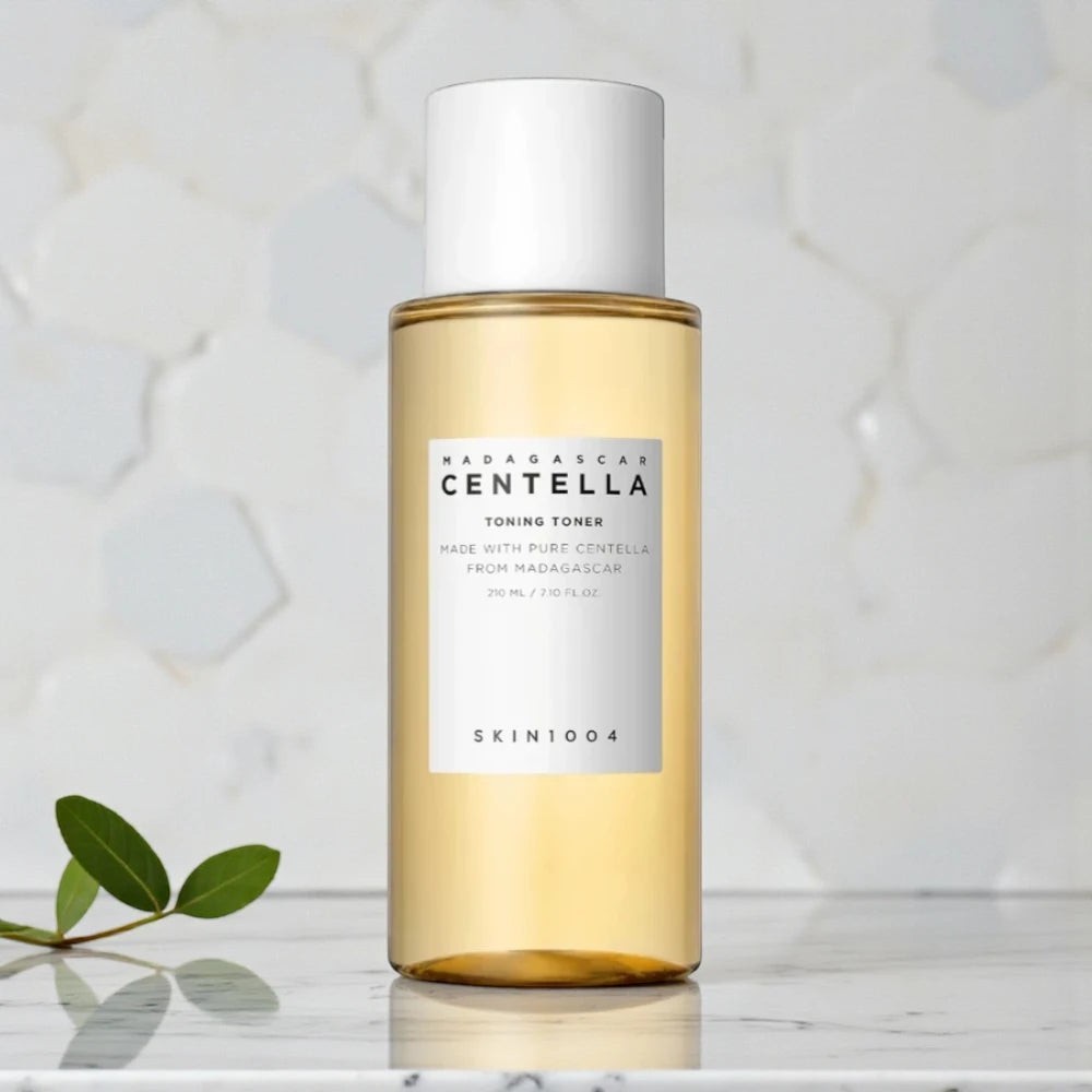 Skin TOGO SKIN1004 Madagascar Centella Toning Toner in a clear 400ml bottle with a white cap on a marble surface.