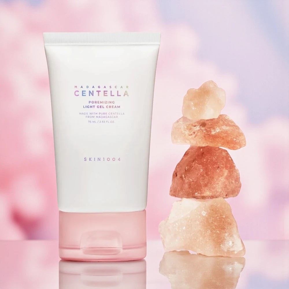 Skin TOGO SKIN1004 Poremizing Light Gel Cream in a white tube with a pink cap next to a stack of pink salt rocks.