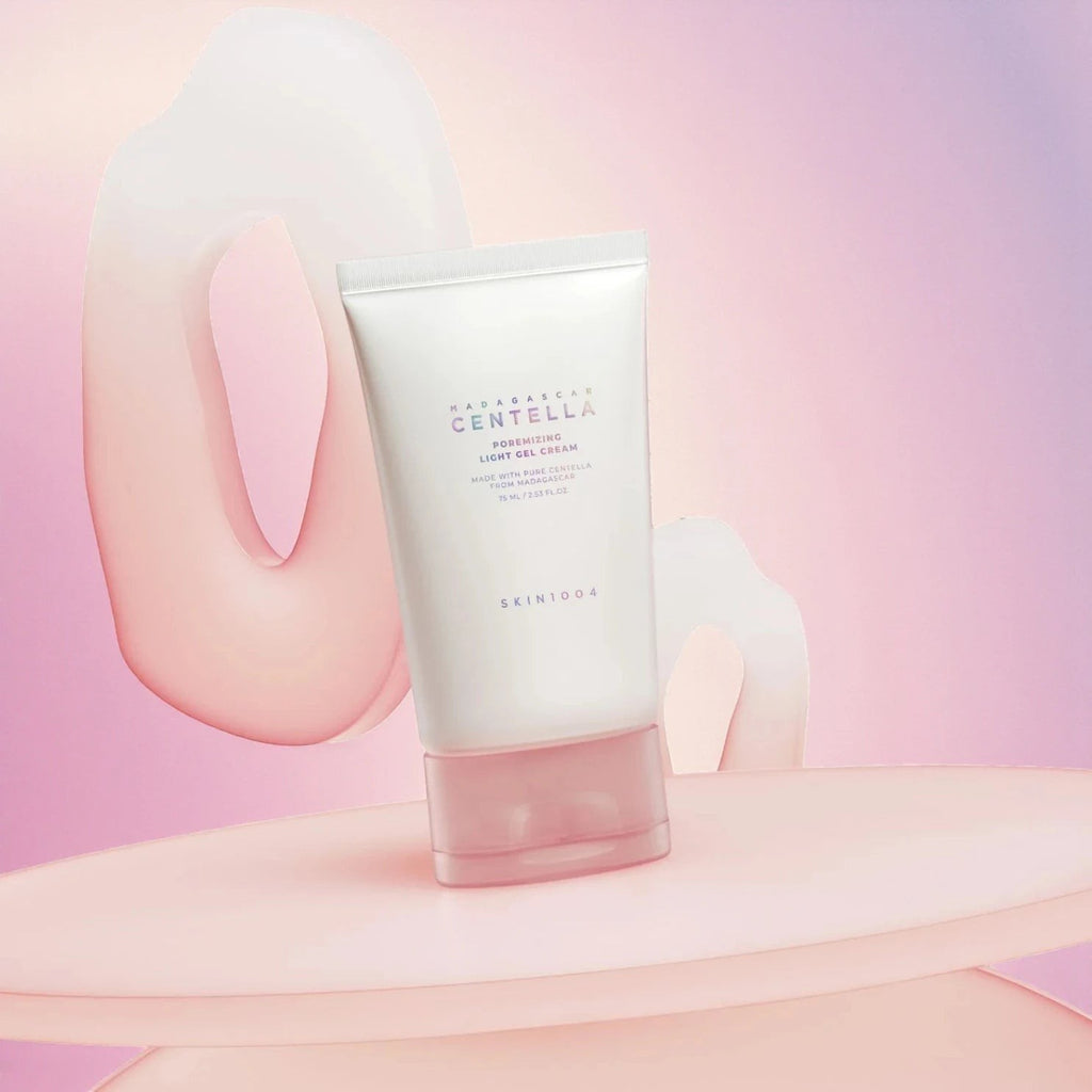 Skin TOGO SKIN1004 Poremizing Light Gel Cream in a white tube with a pink cap, set on a soft pink platform.